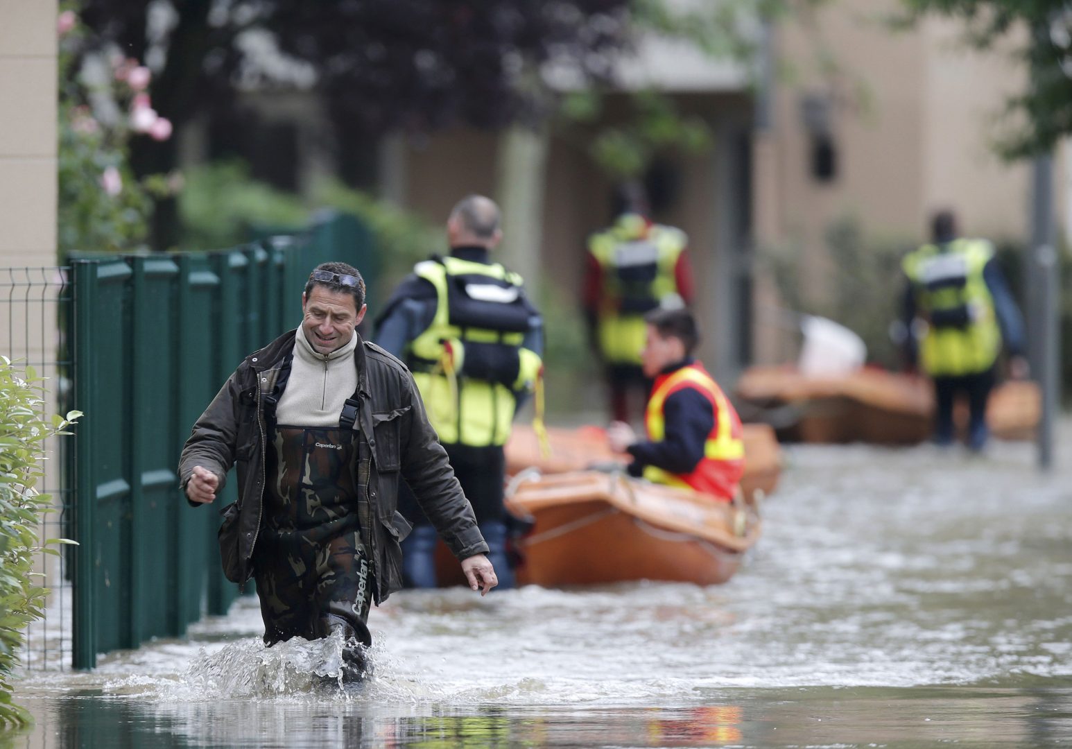 A man walks through a flooded area in Longjumeau, southern Paris, after days of almost non-stop rain caused flooding in the country, June 2, 2016. REUTERS/Christian Hartmann
