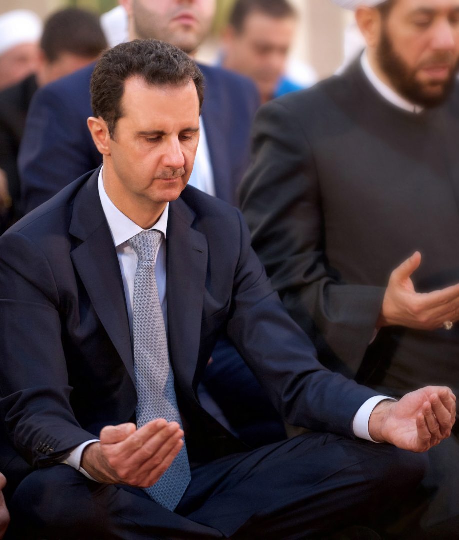 A picture released by Syria's official news agency SANA shows Syrian President Bashar al-Assad peforming the morning prayer of the Muslim holiday of Eid al-Adha at the Al-Adel mosque in Damascus on September 24, 2015, in a rare public appearance for the embattled regime head. Assad attended the prayer of the Muslilm holiday of sacrifice along with state and ruling Baath party officials as well as a number of Muslim religious leaders and civilians, Syria's official news agency SANA reported. AFP PHOTO / HO / SANA == RESTRICTED TO EDITORIAL USE - MANDATORY CREDIT "AFP PHOTO / HO / SANA" - NO MARKETING NO ADVERTISING CAMPAIGNS - DISTRIBUTED AS A SERVICE TO CLIENTS ==
