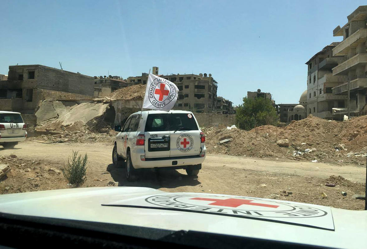 FILE -- In this Wednesday, June 1, 2016, file photo released by the International Committee for the Red Cross, shows the first humanitarian aid convoy in Daraya, Syria. The Syrian Arab Red Crescent and the United Nations have delivered food aid to the Damascus suburb of Daraya for the first time since it came under siege in 2012, hours after the U.N. said the Syrian government had approved access to 15 of the 19 besieged areas within Syria. (ICRC via AP, File)