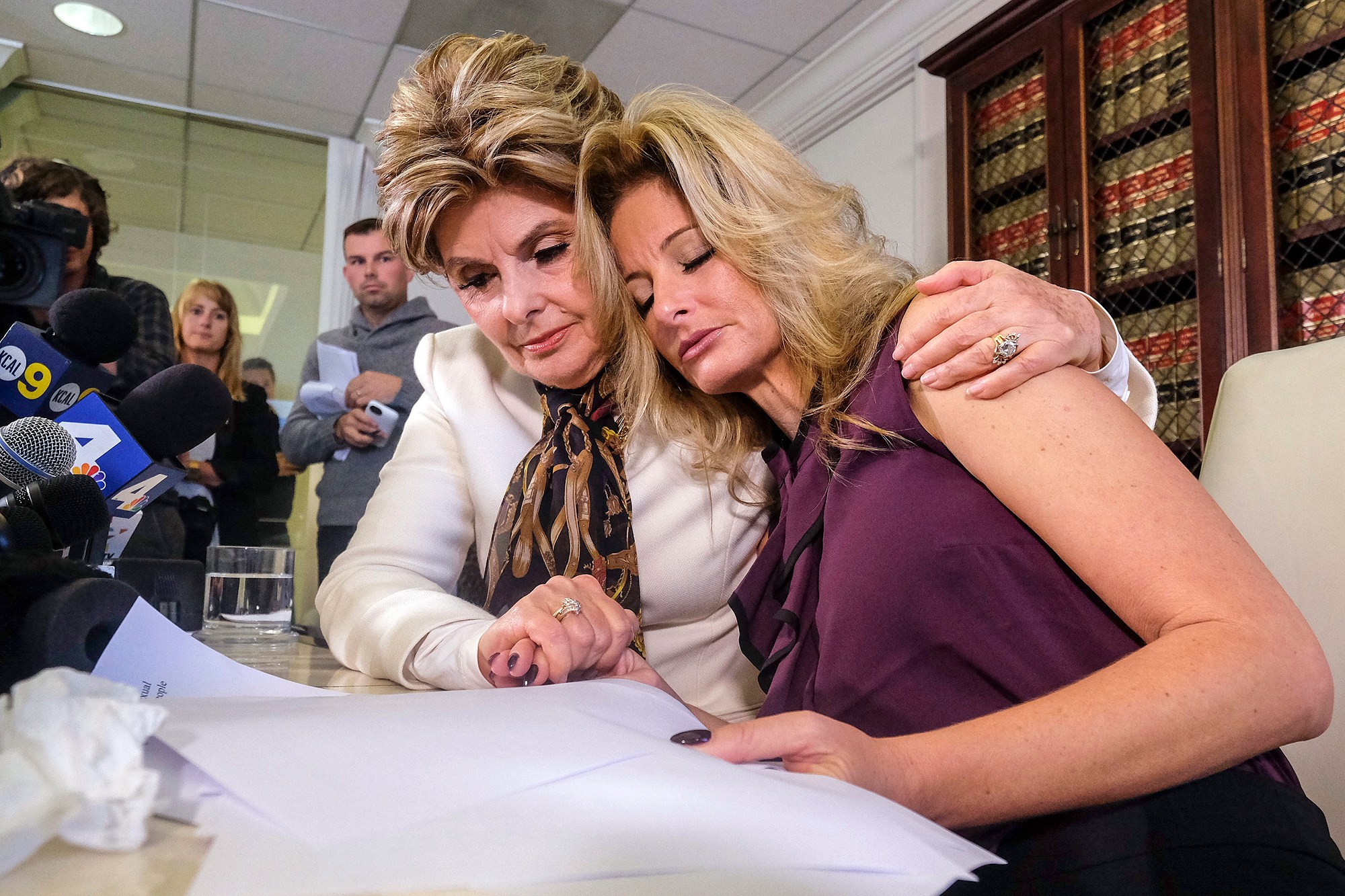 Attorney Gloria Allred, left, comforts Summer Zervos during a news conference in Los Angeles, Friday Oct. 14, 2016. Zervos, a former contestant on "The Apprentice" says Republican presidential candidate Donald Trump made unwanted sexual contact with her at a Beverly Hills hotel in 2007. Zervos is among several women who have made sexual allegations against the Republican nominee. He has strenuously denied them. (AP Photo/Ringo H.W. Chiu)