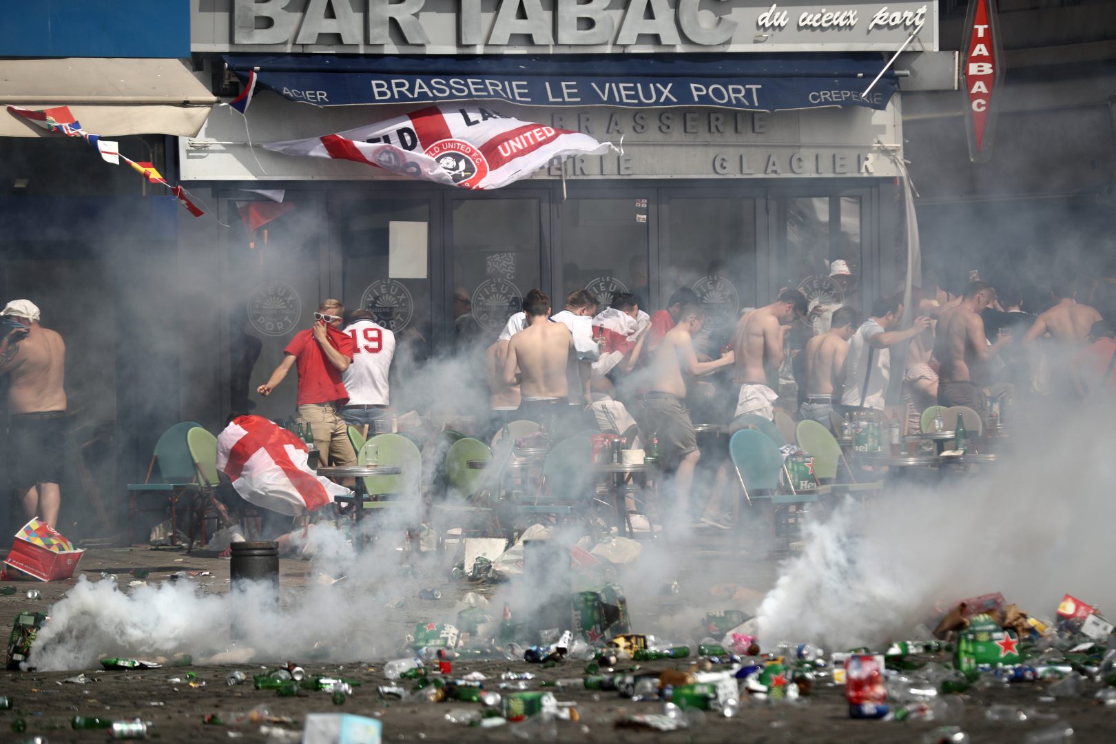 MARSEILLE, FRANCE - JUNE 11:  England fans react after police sprayed tear gas during clashes ahead of the game against Russia later today on June 11, 2016 in Marseille, France.  Football fans from around Europe have descended on France for the UEFA Euro 2016 football tournament.  (Photo by Carl Court/Getty Images)