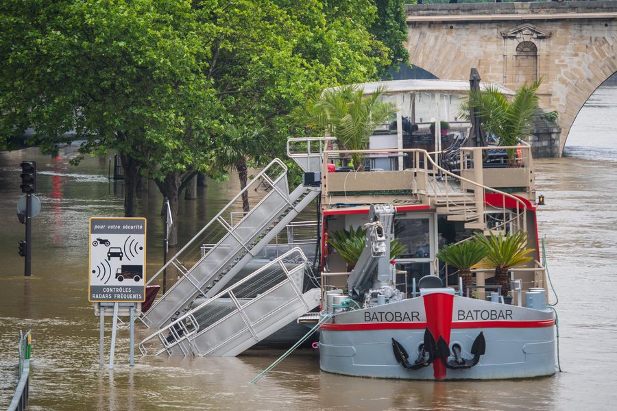 epa05340820 A view of the Seine river from Saint Louis Island, shows a partially submerged restaurant boat, in Paris, France, 01 June 2016. Heavy rains hit a quarter of the French territory over several days causing floods. EPA/CHRISTOPHE PETIT TESSON