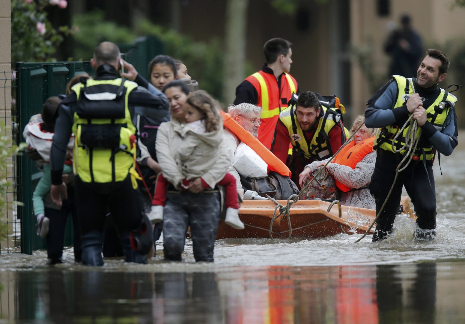 French firefighters on a small boat evacuate residents from a flooded area in Longjumeau, southern Paris, after days of almost non-stop rain caused flooding in the country, June 2, 2016. REUTERS/Christian Hartmann