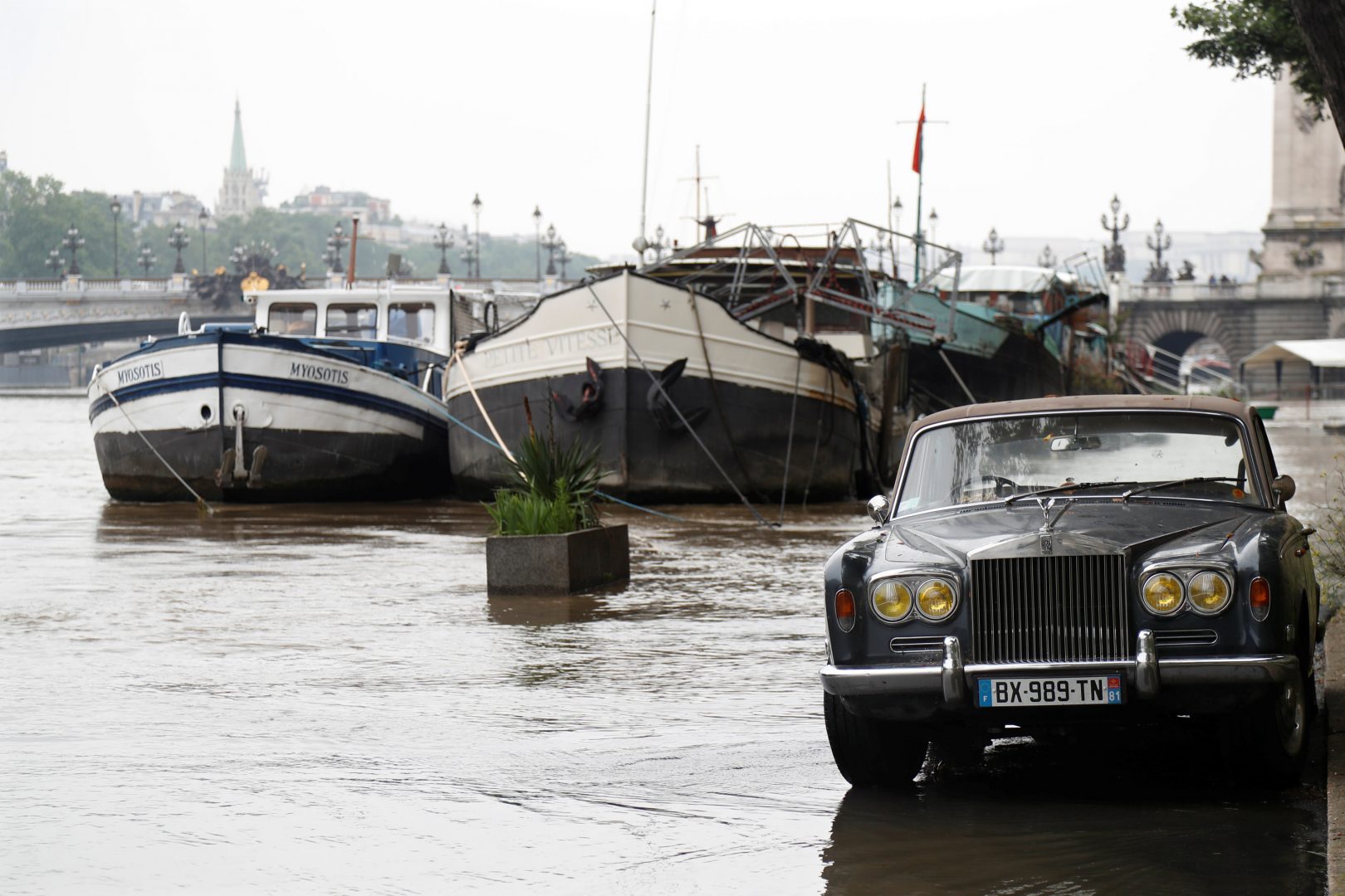 A Rolls-Royce is parked as high waters causes flooding along the Seine River in Paris