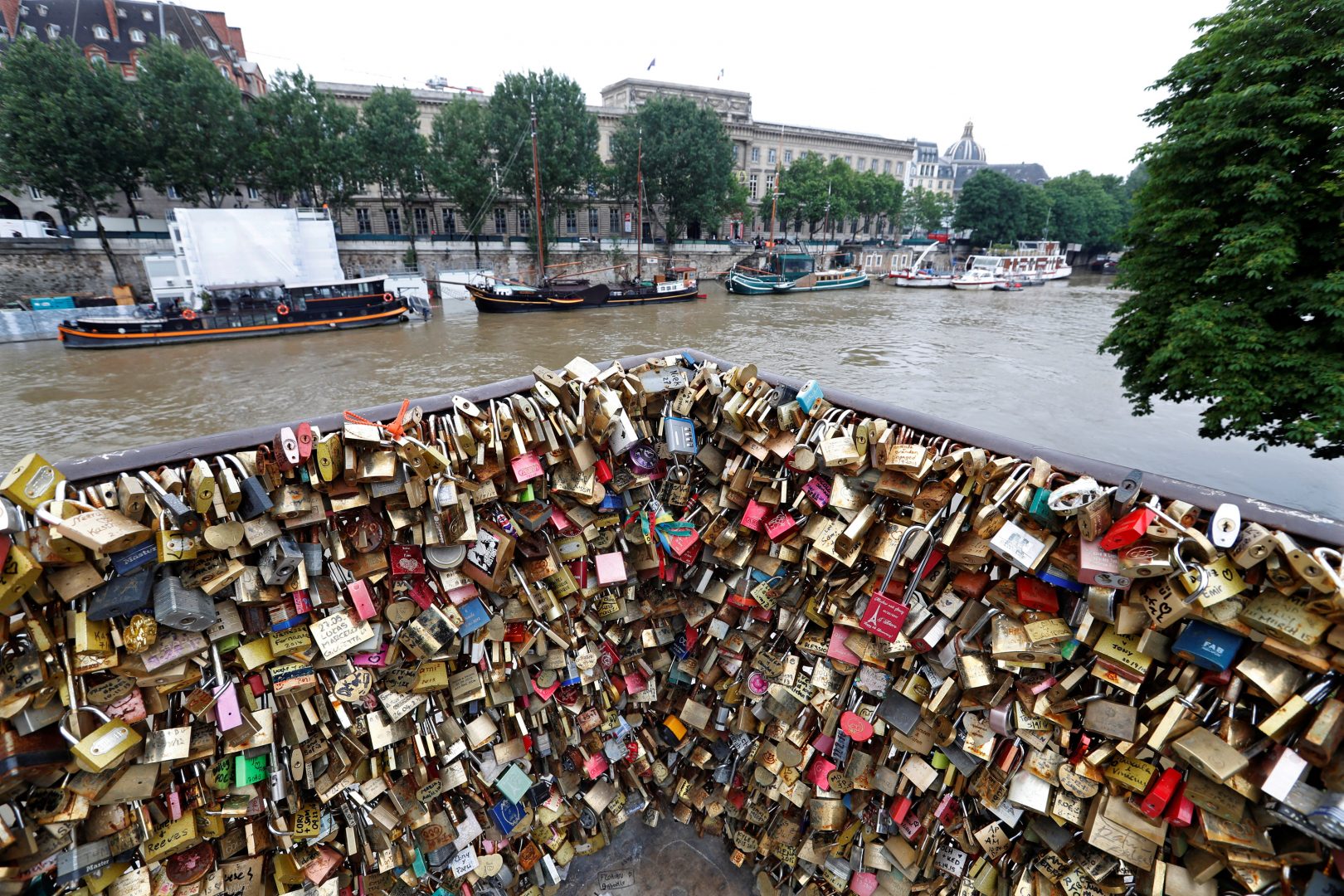 Padlocks clipped by lovers are seen in front of the flooded river-side of the River Seine in Paris, France, June 1, 2016. REUTERS/Charles Platiau
