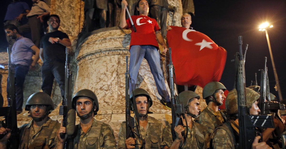 Turkish soldiers secure the area as supporters of Turkey's President Recep Tayyip Erdogan protest in Istanbul's Taksim square, early Saturday, July 16, 2016. Turkey's prime minister says a group within Turkey's military has engaged in what appeared to be an attempted coup. Binali Yildirim told NTV television: "it is correct that there was an attempt." (AP Photo/Emrah Gurel)