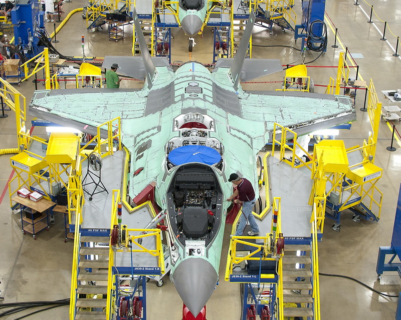 Workers can be seen on the moving line and forward fuselage assembly areas for the F-35 Joint Strike Fighter at Lockheed Martin Corp's factory located in Fort Worth, Texas in this October 13, 2011 handout photo provided by Lockheed Martin. Lockheed Martin Corp on February 25, 2013 said there was no evidence that a lithium-ion battery contributed to a Feb. 14 incident that caused smoke in the cockpit of an F-35 test plane. Lockheed spokesman Michael Rein said initial reviews indicated a potential failure in the plane's cooling system, which had been removed from the aircraft for further study. Picture taken October 13, 2011. REUTERS/Lockheed Martin/Randy A. Crites/Handout (UNITED STATES - Tags: MILITARY) ATTENTION EDITORS - THIS IMAGE WAS PROVIDED BY A THIRD PARTY. FOR EDITORIAL USE ONLY. NOT FOR SALE FOR MARKETING OR ADVERTISING CAMPAIGNS. THIS PICTURE IS DISTRIBUTED EXACTLY AS RECEIVED BY REUTERS, AS A SERVICE TO CLIENTS - RTR3EAKK